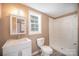 Clean bathroom with white fixtures, including a shower stall and vanity at 15 Gumtree St, Wadesboro, NC 28170