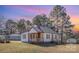 Charming home exterior featuring a metal roof and covered front porch at 15 Gumtree St, Wadesboro, NC 28170