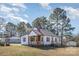 Charming home featuring a cozy front porch, white siding, and a contrasting dark metal roof at 15 Gumtree St, Wadesboro, NC 28170