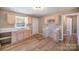 Bright kitchen featuring sleek, new flooring and plenty of cabinet space at 15 Gumtree St, Wadesboro, NC 28170