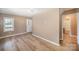Bright room featuring neutral walls, new flooring, and an adjacent bathroom at 15 Gumtree St, Wadesboro, NC 28170