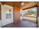 Charming covered front porch with wood railing and brick accents at 15 Gumtree St, Wadesboro, NC 28170