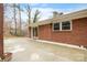 The back of a brick home shows a large concrete patio with sliding door access to the house at 1525 16Th Avenue Nw Cir, Hickory, NC 28601
