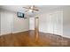 Bedroom featuring hardwood floors, ceiling fan, TV, and access to the closet at 1525 16Th Avenue Nw Cir, Hickory, NC 28601