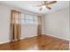 Bedroom with hardwood floors, ceiling fan, window and simple decor at 1525 16Th Avenue Nw Cir, Hickory, NC 28601