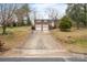 Charming brick home with a two-car garage, lush landscaping, and a long driveway at 1525 16Th Avenue Nw Cir, Hickory, NC 28601