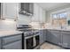 Modern kitchen with stainless steel appliances, gray cabinets, and a white subway tile backsplash at 1525 16Th Avenue Nw Cir, Hickory, NC 28601