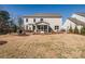 The backyard features a patio with outdoor seating, ideal for entertaining or relaxing in nature at 15606 Walnut Hill Dr, Charlotte, NC 28278