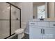 Modern bathroom featuring a tiled shower with glass door and vanity at 15606 Walnut Hill Dr, Charlotte, NC 28278