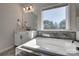 Bathroom with vanity, tub, and large window offering plenty of light at 15606 Walnut Hill Dr, Charlotte, NC 28278