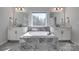Bathroom with dual vanities, soaking tub and marble tile at 15606 Walnut Hill Dr, Charlotte, NC 28278