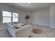 Bright bonus room with a large window, neutral color scheme, and comfortable seating area at 15606 Walnut Hill Dr, Charlotte, NC 28278