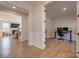 Hallway view showcasing wood flooring and easy access to the living room and a home office with French doors at 15606 Walnut Hill Dr, Charlotte, NC 28278