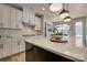 Kitchen with an island, modern pendant lighting, white cabinets, and stainless steel appliances at 15606 Walnut Hill Dr, Charlotte, NC 28278