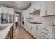 Bright kitchen featuring white cabinetry, stainless steel appliances, and hardwood floors throughout at 15606 Walnut Hill Dr, Charlotte, NC 28278