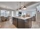 Spacious island kitchen with a sink, pendant lighting, and an open layout to living room at 15606 Walnut Hill Dr, Charlotte, NC 28278