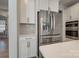Modern kitchen featuring stainless steel appliances, white cabinetry, and a stylish backsplash at 15606 Walnut Hill Dr, Charlotte, NC 28278