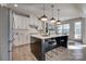 Bright kitchen featuring a center island with seating, modern pendant lighting, and stainless steel appliances at 15606 Walnut Hill Dr, Charlotte, NC 28278