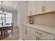 Bright kitchen featuring white cabinetry, sleek countertops, and an adjacent dining area at 15606 Walnut Hill Dr, Charlotte, NC 28278