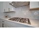 Modern kitchen with stainless steel gas range, white tile backsplash, and sleek countertops at 15606 Walnut Hill Dr, Charlotte, NC 28278