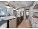 Open kitchen layout with an island, stainless steel appliances, and hardwood floors that lead to the dining area at 15606 Walnut Hill Dr, Charlotte, NC 28278