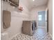 Spacious laundry room with washer and dryer and decorative tile floor at 15606 Walnut Hill Dr, Charlotte, NC 28278
