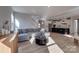 Spacious living room with hardwood floors, a comfortable sectional sofa, and an open layout connecting to the kitchen at 15606 Walnut Hill Dr, Charlotte, NC 28278