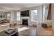 Bright and airy living room featuring a fireplace, large windows, and hardwood floors at 15606 Walnut Hill Dr, Charlotte, NC 28278