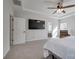 Spacious main bedroom with a sitting area and large TV at 15606 Walnut Hill Dr, Charlotte, NC 28278