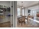 Open-concept dining area flowing into a living room with a view of the walk-in pantry at 15606 Walnut Hill Dr, Charlotte, NC 28278