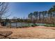 Well-maintained community tennis court surrounded by lush trees, providing a recreational amenity at 15606 Walnut Hill Dr, Charlotte, NC 28278