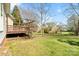 View of the home's wooden deck and partially fenced backyard with mature trees and green grass at 1730 Townsend Ln, Rock Hill, SC 29730