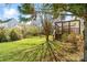Green grass, trees and shrubbery define a cozy backyard and wooden deck in a peaceful setting at 1730 Townsend Ln, Rock Hill, SC 29730