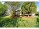 Spacious backyard featuring a wooden deck, lush green lawn, and mature trees for privacy at 1730 Townsend Ln, Rock Hill, SC 29730