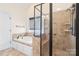 The bathroom is equipped with a shower, soaking tub, and tiled flooring in neutral tones at 1730 Townsend Ln, Rock Hill, SC 29730