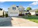 A view of the home showcasing its large driveway, attached garage, and well-maintained landscaping at 1730 Townsend Ln, Rock Hill, SC 29730