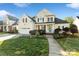 Charming two-story home with a manicured lawn, attached garage, and inviting front porch at 1730 Townsend Ln, Rock Hill, SC 29730