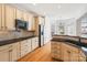 This updated kitchen boasts stone backsplash, stainless appliances, and a charming breakfast nook with bright windows at 1730 Townsend Ln, Rock Hill, SC 29730