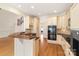 This spacious kitchen features sleek black countertops, custom cabinetry, and hardwood flooring throughout at 1730 Townsend Ln, Rock Hill, SC 29730