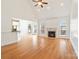 Spacious living room featuring a cozy fireplace, hardwood floors, high ceiling, and large windows at 1730 Townsend Ln, Rock Hill, SC 29730