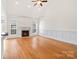 Spacious living room featuring a cozy fireplace, hardwood floors, a high ceiling, and large windows at 1730 Townsend Ln, Rock Hill, SC 29730