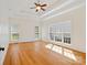 A sun-filled main bedroom featuring hardwood floors, a tray ceiling, and bright windows at 1730 Townsend Ln, Rock Hill, SC 29730