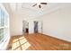 A sunny main bedroom boasts hardwood floors and a decorative tray ceiling with bright windows at 1730 Townsend Ln, Rock Hill, SC 29730