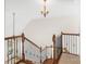Staircase with hardwood steps, wrought iron railings and a chandelier at 1730 Townsend Ln, Rock Hill, SC 29730