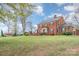 A beautiful view of a red brick home, showcasing its well-maintained lawn and traditional architectural style at 1783 Reepsville Rd, Lincolnton, NC 28092
