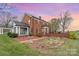 Elegant brick home with manicured landscaping at sunset, highlighting its charming architecture and inviting outdoor space at 1783 Reepsville Rd, Lincolnton, NC 28092
