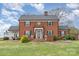 Charming two-story brick home with a manicured lawn, mature landscaping, and a classic architectural design at 1783 Reepsville Rd, Lincolnton, NC 28092