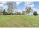 Expansive lush green lawn surrounding a classic brick home, enhanced by mature trees and landscaping at 1783 Reepsville Rd, Lincolnton, NC 28092