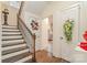 Entryway featuring a staircase with iron railings, decorated doors, and hardwood floors creating a welcoming home at 1783 Reepsville Rd, Lincolnton, NC 28092