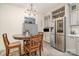 Eat-in kitchen features a round dining table, stainless steel refrigerator, and grey cabinets at 1783 Reepsville Rd, Lincolnton, NC 28092